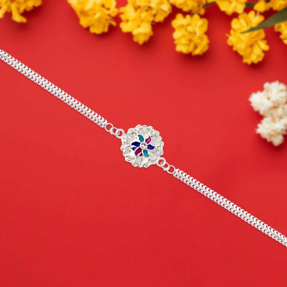 Elegant Silver Floral Rakhi With Enamel Detailing And Dual Chain Design