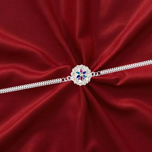 Elegant Silver Floral Rakhi With Enamel Detailing And Dual Chain Design